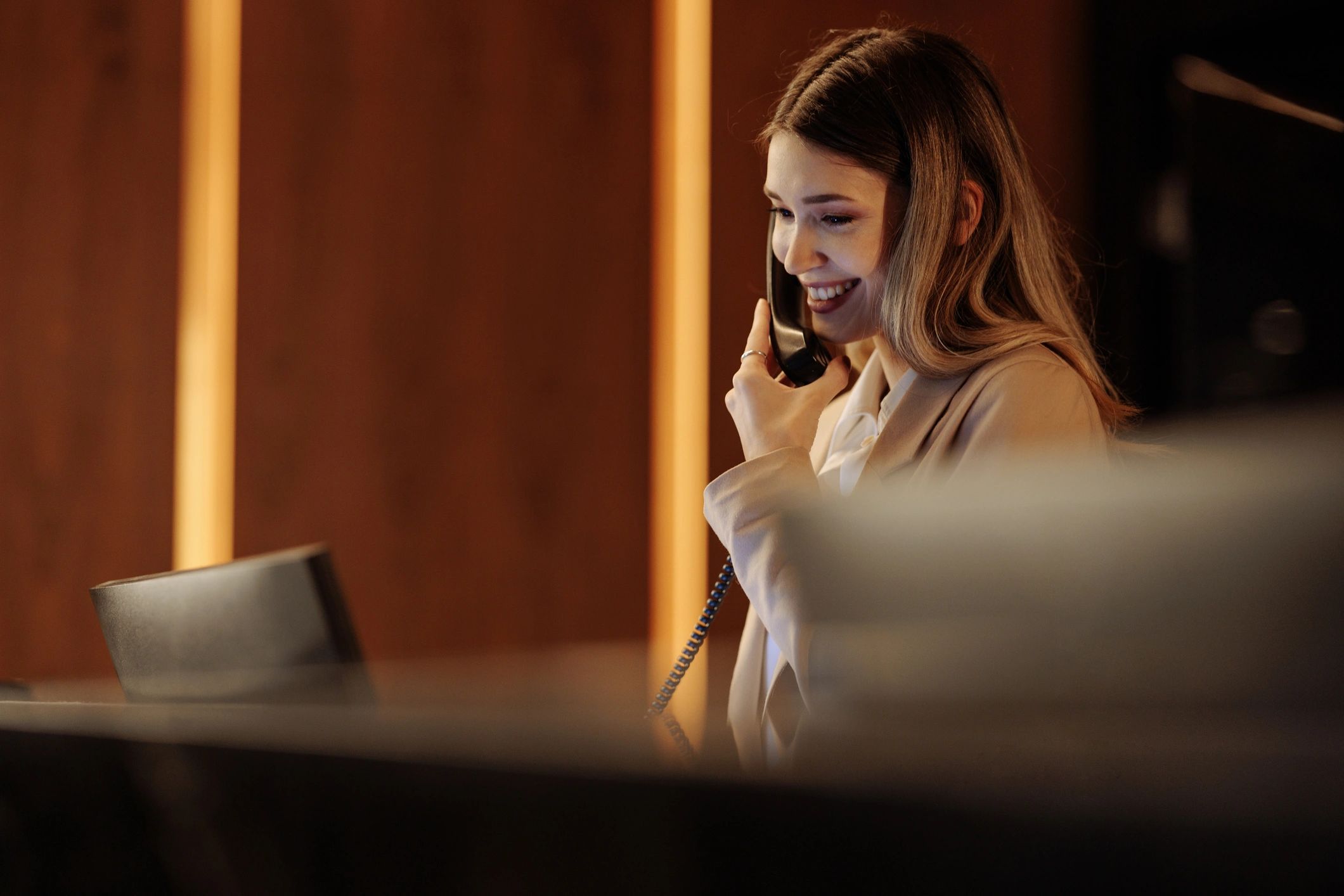 Receptionist answering calls in a modern office